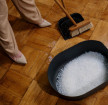 person cleaning a wooden flooring